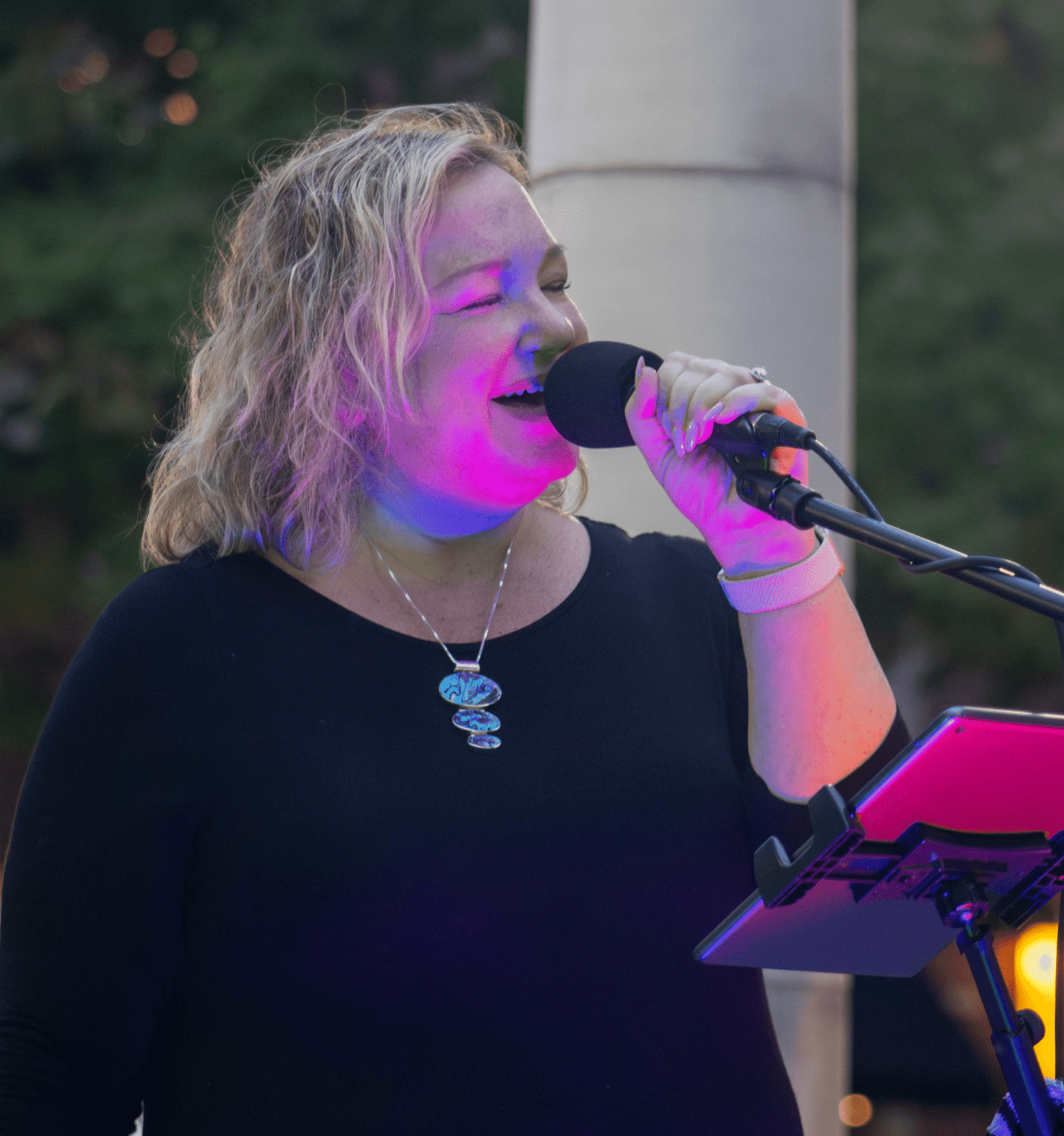 Singer performing at an outdoor concert