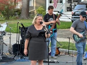 Woman performing at an outdoor concert.
