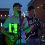 Musicians performing at a concert at night