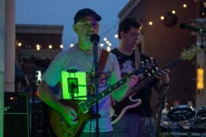 Musicians performing at a concert at night