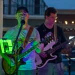 Musicians performing at a concert at night