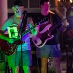 Musicians performing at a concert at night