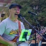 Man performing at an outdoor concert.