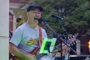 Man performing at an outdoor concert.