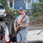 Man performing at an outdoor concert.