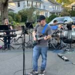Man performing at an outdoor concert.