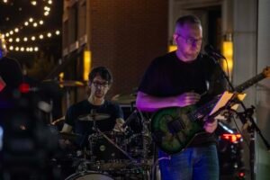 Musicians performing at a concert at night.