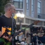 Man performing at an outdoor concert.