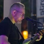 Man performing at an outdoor concert.