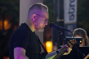 Man performing at an outdoor concert.