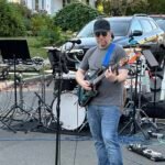 Man performing at an outdoor concert.