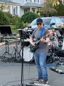 Man performing at an outdoor concert.