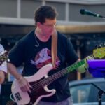 Man performing at an outdoor concert.