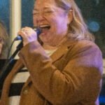 Woman performing at a concert.